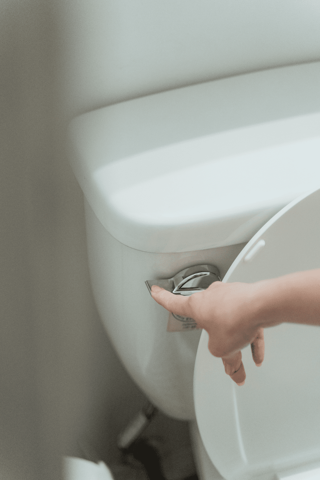 A hand flushing a toilet: https://www.pexels.com/photo/hand-flushing-toilet-7622581/